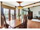 Charming dining room with wood floors, dining table, access to the back patio, and a decorative light fixture at 6505 Miramar Ct, Indianapolis, IN 46250