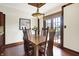 Well-lit dining area with a wooden table, chairs, wood floors, chandelier, and sliding door access to the outside at 6505 Miramar Ct, Indianapolis, IN 46250
