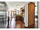 Open-concept kitchen featuring stainless steel appliances, granite countertops, wood cabinets, and hardwood floors at 6505 Miramar Ct, Indianapolis, IN 46250