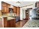 Kitchen showcasing granite countertops, stainless steel appliances, ample wood cabinetry, and hardwood flooring at 6505 Miramar Ct, Indianapolis, IN 46250