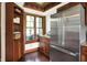 Kitchen area with stainless steel refrigerator, wood cabinets, granite counters, built-in shelving, and hardwood flooring at 6505 Miramar Ct, Indianapolis, IN 46250