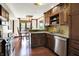 Bright kitchen with stainless steel appliances, granite countertops, wood cabinets, and an adjacent dining area at 6505 Miramar Ct, Indianapolis, IN 46250