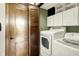 Laundry area features a washer and dryer, plus custom wooden pocket doors, and overhead storage at 6505 Miramar Ct, Indianapolis, IN 46250