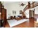 Spacious living room with hardwood floors, fireplace, and stairs leading to the loft at 6505 Miramar Ct, Indianapolis, IN 46250