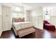 Main bedroom with hardwood floors, accent wall, window seat, and open access to a sitting room at 6505 Miramar Ct, Indianapolis, IN 46250