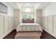 The main bedroom with hardwood floors, a high ceiling, and built-in cabinets surrounding a window seat at 6505 Miramar Ct, Indianapolis, IN 46250