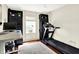 Bright room features a treadmill, a standing desk and bookshelves at 6505 Miramar Ct, Indianapolis, IN 46250