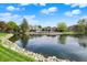 Scenic view of community pond and landscaping with a swimming pool in the background on a bright sunny day at 6505 Miramar Ct, Indianapolis, IN 46250