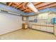 Basement space with painted walls, vinyl tile flooring and cabinetry with a countertop at 6530 Kingswood Dr, Indianapolis, IN 46256