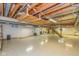 Unfinished basement with open ceiling, vinyl tile flooring and ample space for storage or recreation at 6530 Kingswood Dr, Indianapolis, IN 46256