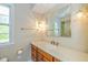 Bathroom featuring wood vanity and gold fixtures at 6530 Kingswood Dr, Indianapolis, IN 46256