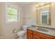 Powder room with vanity sink, granite countertop, and wood cabinets at 6530 Kingswood Dr, Indianapolis, IN 46256