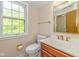 Bathroom featuring wood vanity, toilet, and gold fixtures at 6530 Kingswood Dr, Indianapolis, IN 46256