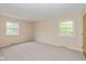 Bright bedroom featuring neutral walls, carpet, and natural light from the windows at 6530 Kingswood Dr, Indianapolis, IN 46256