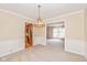 Dining room with neutral carpet, chandelier, wainscoting and view of the kitchen at 6530 Kingswood Dr, Indianapolis, IN 46256