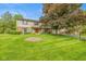 Charming two-story home with well-manicured lawn and mature trees enhancing curb appeal at 6530 Kingswood Dr, Indianapolis, IN 46256
