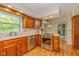 Updated kitchen featuring stainless steel appliances, wooden cabinets and hardwood floors at 6530 Kingswood Dr, Indianapolis, IN 46256