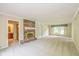 Bright living room featuring a brick fireplace and access to an adjacent bathroom at 6530 Kingswood Dr, Indianapolis, IN 46256