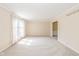 Bright living room with neutral carpet, large window and trim throughout at 6530 Kingswood Dr, Indianapolis, IN 46256