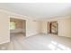 Open living room with neutral carpet, crown moulding, and two access points at 6530 Kingswood Dr, Indianapolis, IN 46256