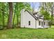 Picture of the back corner of the house with the deck, white siding, dark trim, and lush yard at 6682 English Dr, Avon, IN 46123