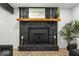 Close up of the gorgeous stone fireplace with wood mantle and contemporary decor at 6682 English Dr, Avon, IN 46123