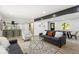 Open living area with modern decor, wood floors, and view into updated kitchen at 6682 English Dr, Avon, IN 46123