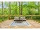 Beautiful wooden deck surrounded by lush trees and outdoor seating at 6682 English Dr, Avon, IN 46123