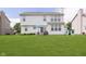 Spacious backyard featuring lush lawn, patio with furniture and white house exterior at 6839 Powder Dr, Indianapolis, IN 46259