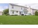 Green backyard with patio set, grill, a small playhouse, and a white two-story house at 6839 Powder Dr, Indianapolis, IN 46259
