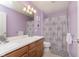 Charming bathroom with double sink vanity, decorative shower curtain, and soft, lavender walls at 6839 Powder Dr, Indianapolis, IN 46259