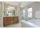 Bathroom with double sink vanity, soaking tub, and glass door shower at 6839 Powder Dr, Indianapolis, IN 46259