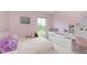 Pink bedroom with a large window, white desk, and bed with plush toys at 6839 Powder Dr, Indianapolis, IN 46259