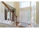 Bright foyer featuring hardwood floors, white trim, and a staircase leading to the upper level of the home at 6839 Powder Dr, Indianapolis, IN 46259