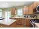 Well-equipped kitchen boasts wood cabinets, stainless steel appliances, and ample counter space for meal preparation at 6839 Powder Dr, Indianapolis, IN 46259