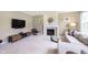Spacious living room features a fireplace, mantel, and large TV at 6839 Powder Dr, Indianapolis, IN 46259