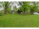 Large backyard with mature trees, providing ample shade and a picturesque view of the property at 7228 Kimberly Ln, Plainfield, IN 46168