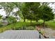View of deck overlooking backyard featuring mature trees and landscaping at 7228 Kimberly Ln, Plainfield, IN 46168