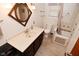 Well-lit bathroom features a brown vanity with modern sink and a unique diamond-shaped mirror at 7228 Kimberly Ln, Plainfield, IN 46168