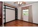 A comfortable bedroom with hardwood floors, natural light, and a built-in closet system at 7228 Kimberly Ln, Plainfield, IN 46168