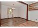 Dining room featuring hardwood floors, wood trim, and built-in display cabinets at 7228 Kimberly Ln, Plainfield, IN 46168