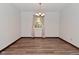 Dining room featuring wood floors and trim, white walls, and a decorative chandelier at 7228 Kimberly Ln, Plainfield, IN 46168