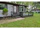 Inviting front porch with glass railing and a cozy spot to enjoy the outdoors at 7228 Kimberly Ln, Plainfield, IN 46168