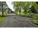 View of detached two-car garage with concrete driveway and partially fenced-in yard at 7228 Kimberly Ln, Plainfield, IN 46168