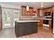 Kitchen featuring an island, wooden cabinets, stainless appliances, and doors to the yard at 7228 Kimberly Ln, Plainfield, IN 46168