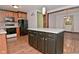 Well-equipped kitchen with island, wooden cabinets, stainless steel appliances, and open floor plan at 7228 Kimberly Ln, Plainfield, IN 46168