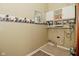 A functional laundry room with storage cabinets and colorful wallpaper details at 7228 Kimberly Ln, Plainfield, IN 46168