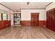 A bright living room with wood-look floors, paneled walls, built-in shelving, and natural light at 7228 Kimberly Ln, Plainfield, IN 46168