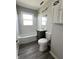 Well-lit bathroom featuring a shower-tub combo, modern vanity, and contemporary fixtures at 728 Lonsvale Dr, Anderson, IN 46013