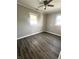 Comfortable bedroom featuring modern vinyl floors and ample natural light from two large windows at 728 Lonsvale Dr, Anderson, IN 46013